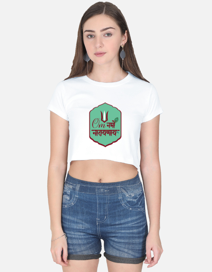 A woman wearing a white half-sleeve crop top with a green badge graphic featuring the "Om Namo Narayanaya" mantra in Devanagari script.