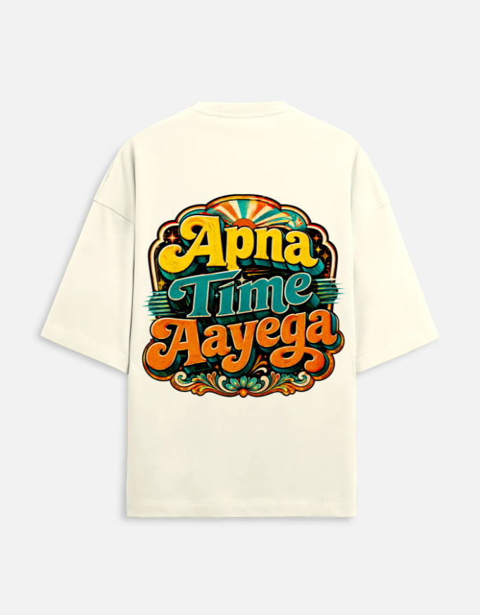 Text: Unisex off-white terry oversized t-shirt featuring a vibrant retro psychedelic typography print on the back with the phrase "Apna Time Aayega" in bold yellow, teal, and orange letters.