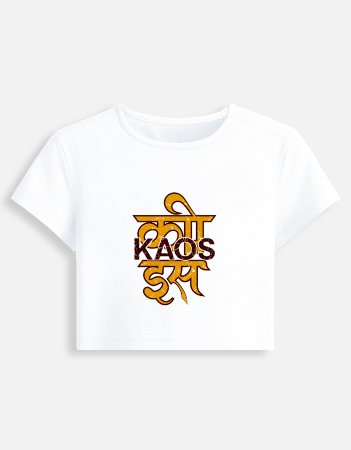 White fitted baby tee featuring a yellow Devanagari script typography graphic on the front with "KAOS" printed across it.
