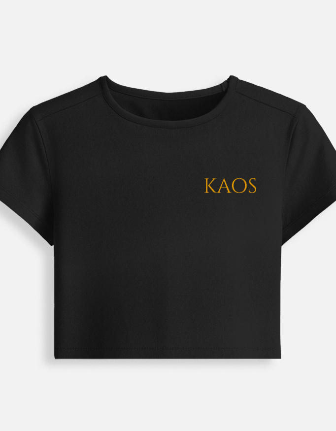 Black fitted baby tee featuring a minimalist gold serif "KAOS" text logo printed on the chest.