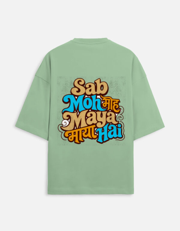 Unisex jade green terry oversized t-shirt featuring a colorful retro typography graphic print on the back with the phrase "Sab Moh Maya Hai" in English and Devanagari script.