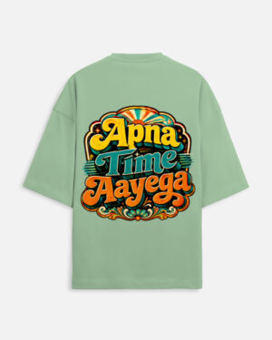 Unisex jade green terry oversized t-shirt featuring a vibrant retro psychedelic typography print on the back with the phrase "Apna Time Aayega" in bold yellow, teal, and orange letters.