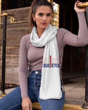 Vertical flat lay view of a white poly-woven satin stole featuring a red bar element with outlined and bold typography reading "SHINE QUIETLY".
